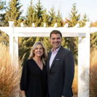 Man and women pose outside